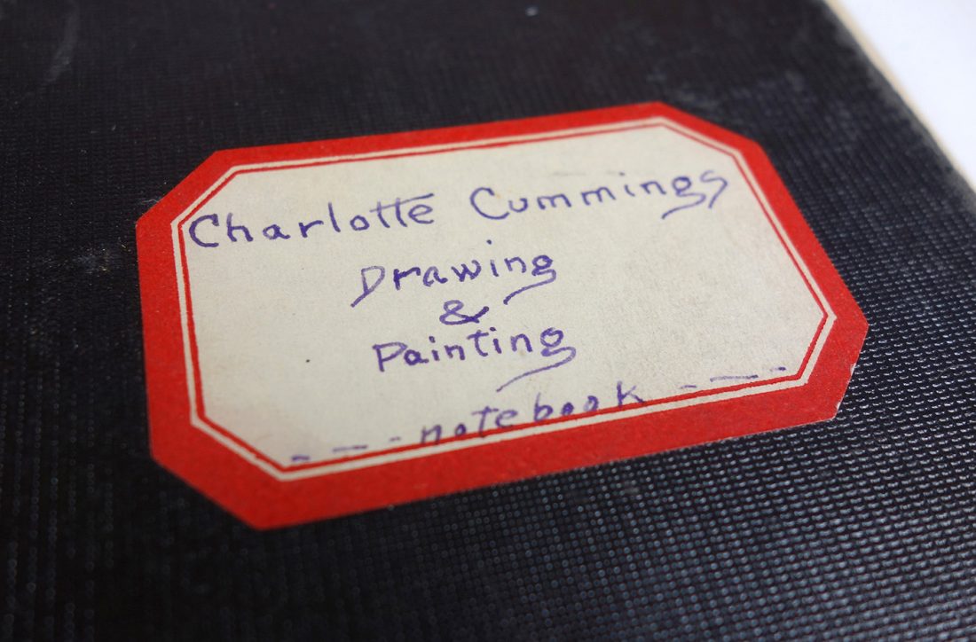 handwritten nameplate on class notebook: reads "Charlotte Cummings, Drawing & Painting, Notebook"