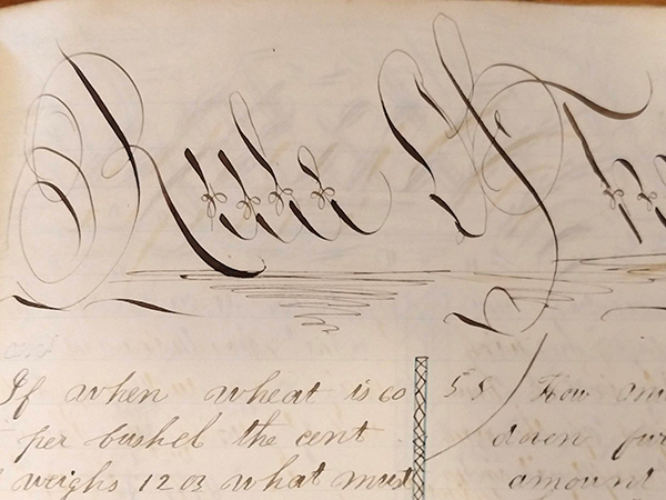 Detail of ornate handwritten word "Rule of Three" from 1859 math workbook of William D. Linebaugh