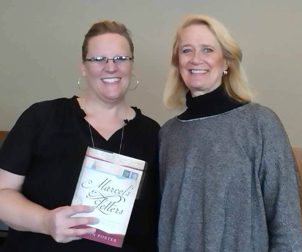 Photo of Sunny Nelson and Carolyn Porter, who is holding a copy of the book "Marcel's Letters"