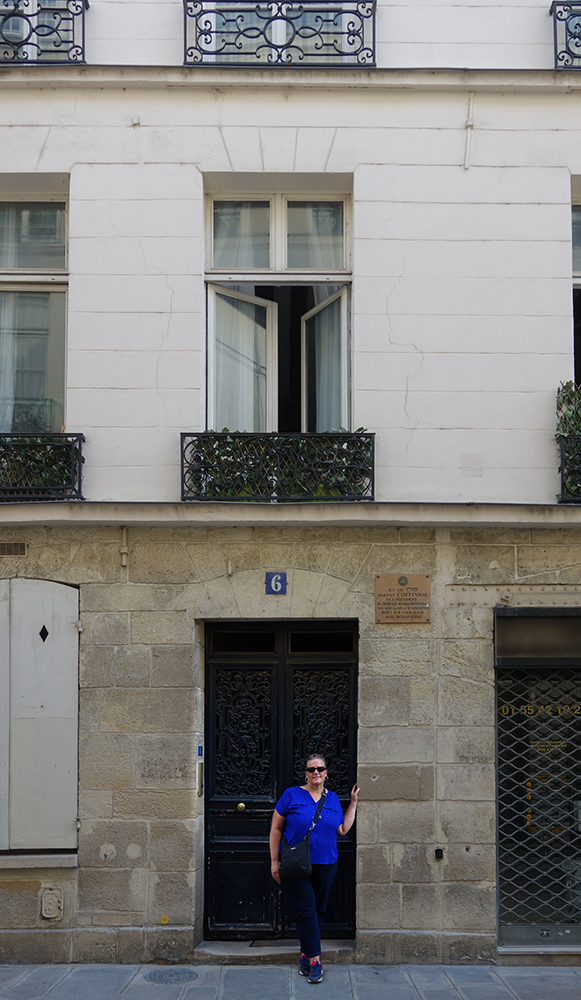 Carolyn Porter standing in front of 6 Rue de Regrattier, Ile Saint Louis, Paris, WWII home of Louise Dillery