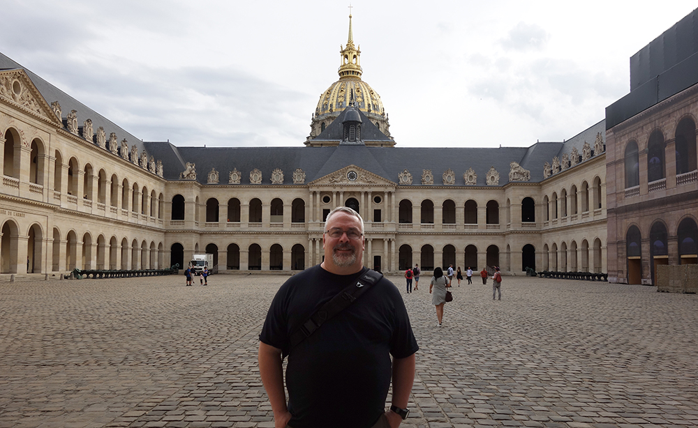 Aaron Gross standing inside the courtyard at Les Invalides, Paris