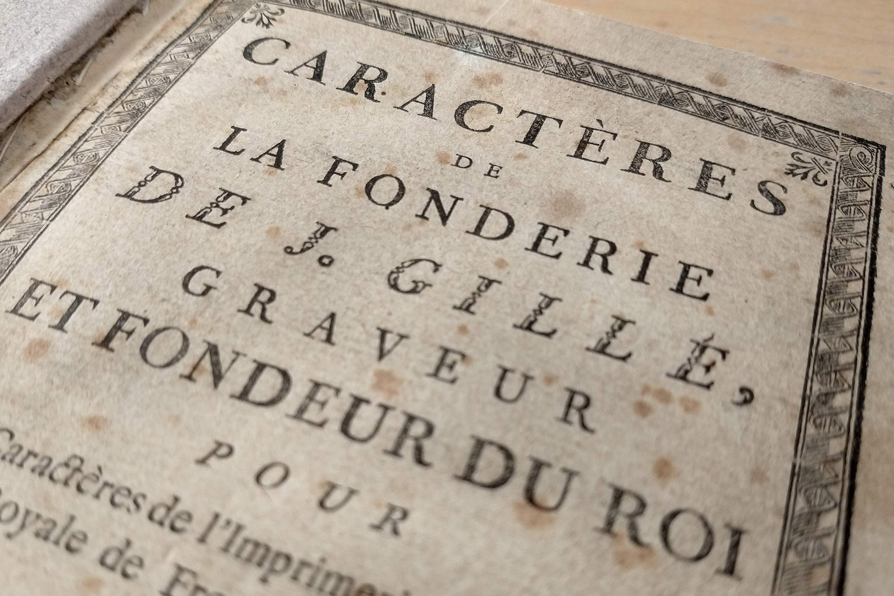 Close up photo of type specimen book "Caractères de La Fonderie de J. Gille"; Letterform Archive, San Francisco